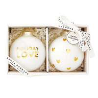 Gift box featuring glass Christmas ornaments with gold lettering and heart designs