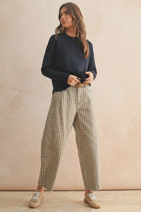 Mini checker pattern barrel pants with navy sweatshirt and beige sneakers