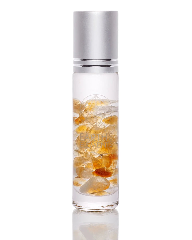 Glass bottle with yellow and orange crystals in liquid for organic essential oils gift