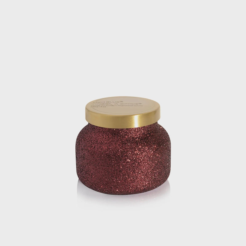 Glittery dark red TINSEL & SPICE GLAM PETITE CANDLE in jar with gold lid