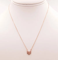 Gold arrow necklace showcased alongside the Dainty Heart Necklace for elegant style