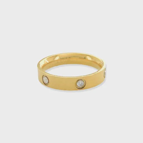 Gold band ring with embedded cubic zirconia, crafted in 18k gold for elegance