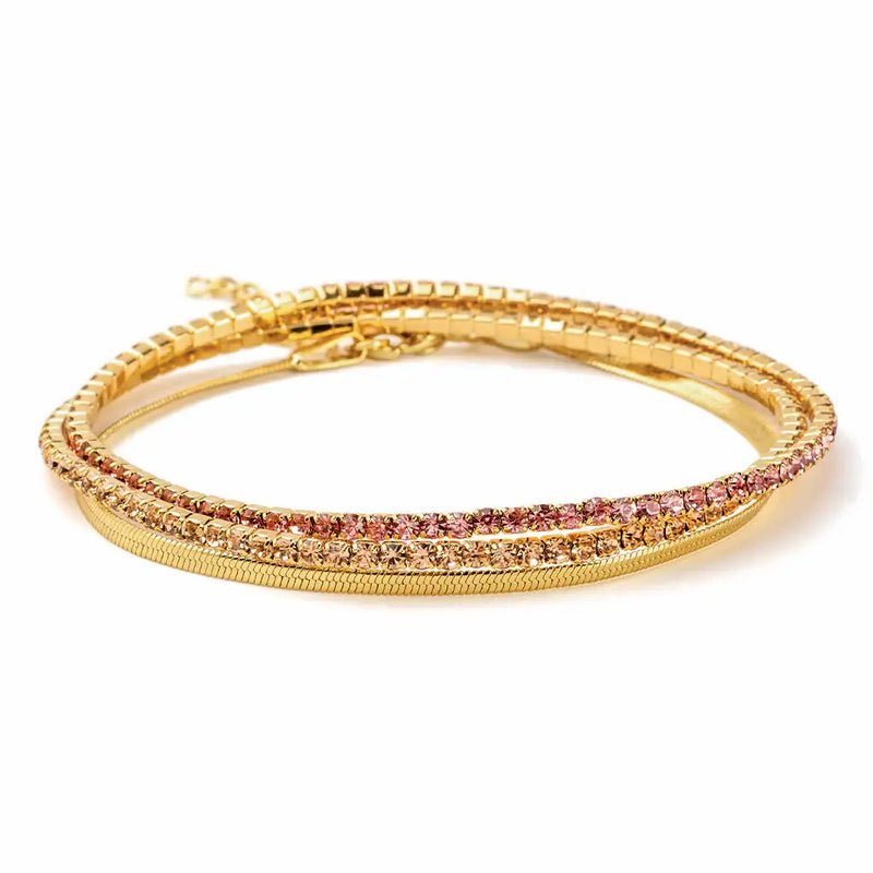 Gold bangle bracelet with pink gemstones from Dainty Gold and Rhinestone Layered Bracelet Set