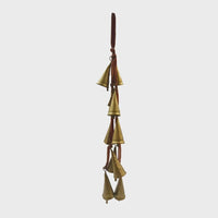 Gold bell wind chime with brown leather strap on velvet ribbon door hanger for elegant decor