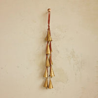 Gold bell wind chime with red string on velvet ribbon door hanger for decorative use