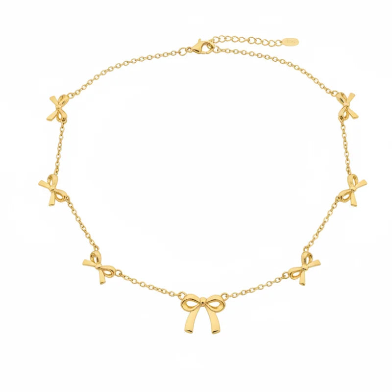Gold bow anklet with delicate chain links and small bows, perfect for free spirit jewelry