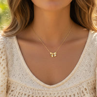 Dainty gold dipped bow necklace with delicate design and adjustable chain