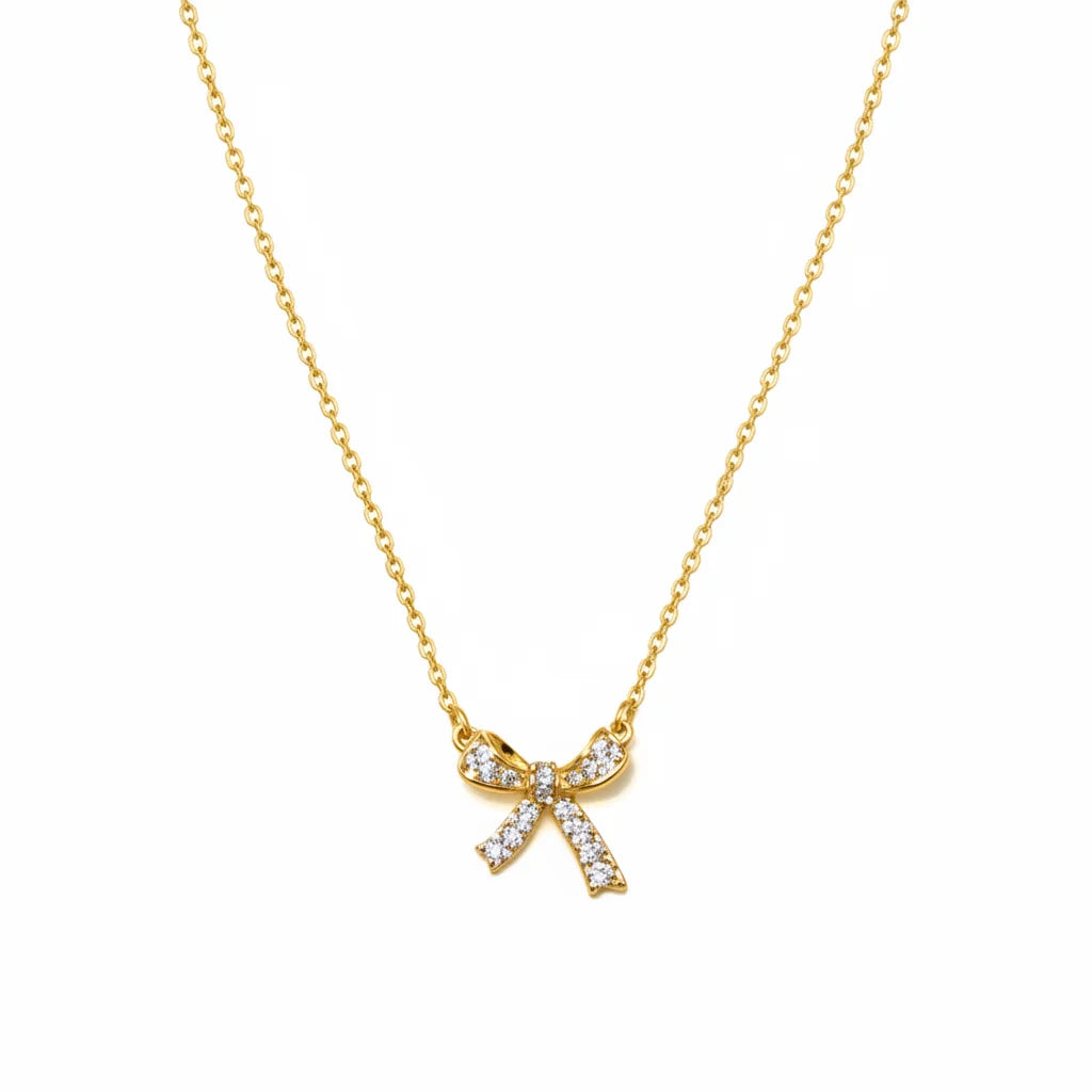 Free Spirit bow charm necklace with gold bow and clear gemstones