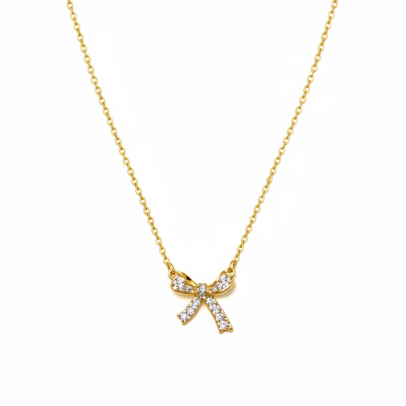 Free Spirit bow charm necklace with gold bow and clear gemstones