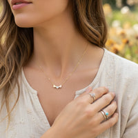 Three tone dainty hearts necklace with gold bow design