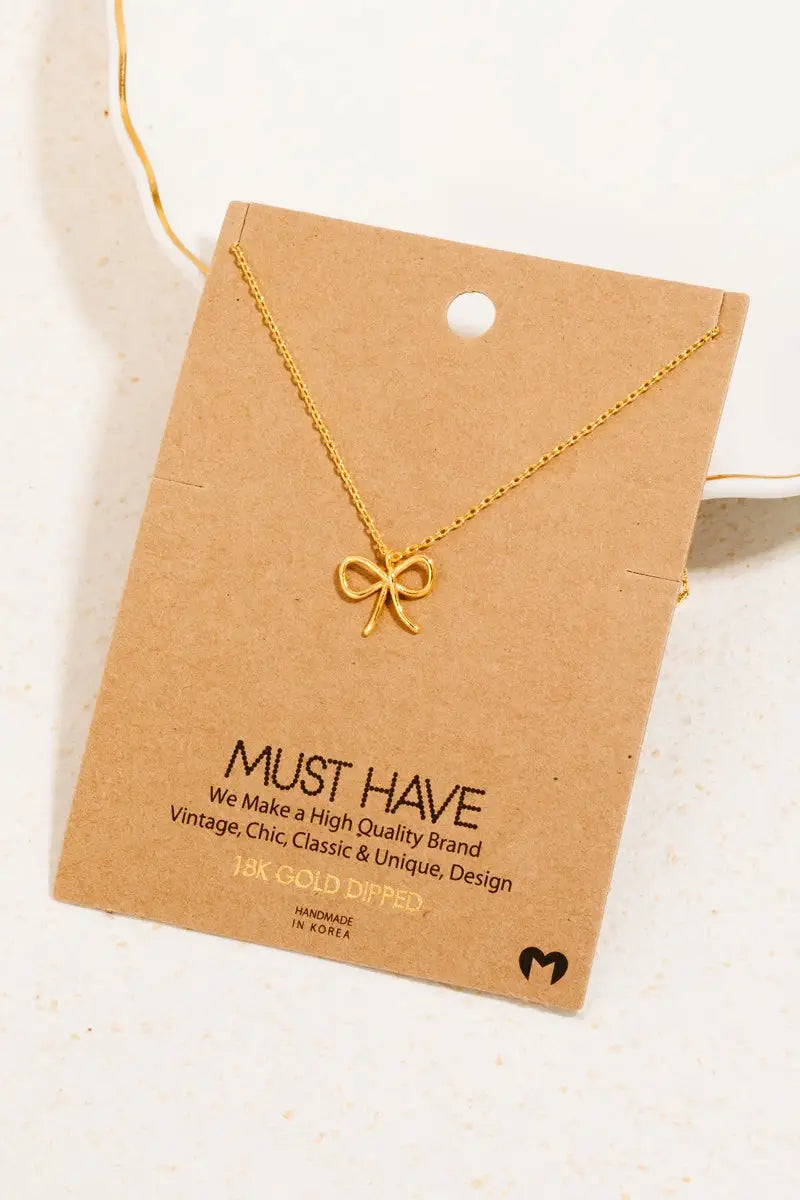 Gold dipped wire ribbon bow pendant necklace showcasing elegance and craftsmanship
