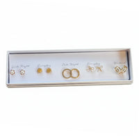 Free Spirit Gold earring journey with pearl-accented bow ring in white box