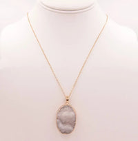 White quartz genuine stone necklace featuring a gold chain and oval druzy pendant