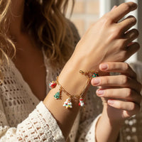 Festive winter Christmas bracelet with gold charms and colorful ceramic pendants