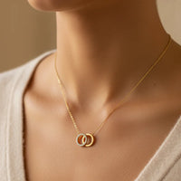 Dainty gold interlocking circles pendant necklace with diamond accents