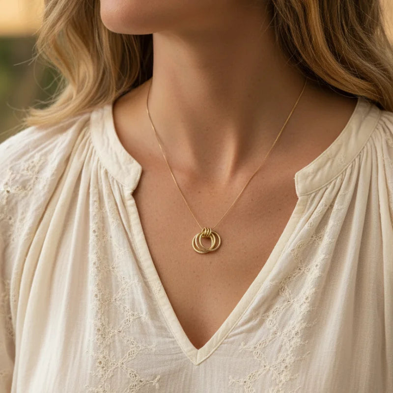 Elegant gold interlocking ring necklace with layered circle chain design