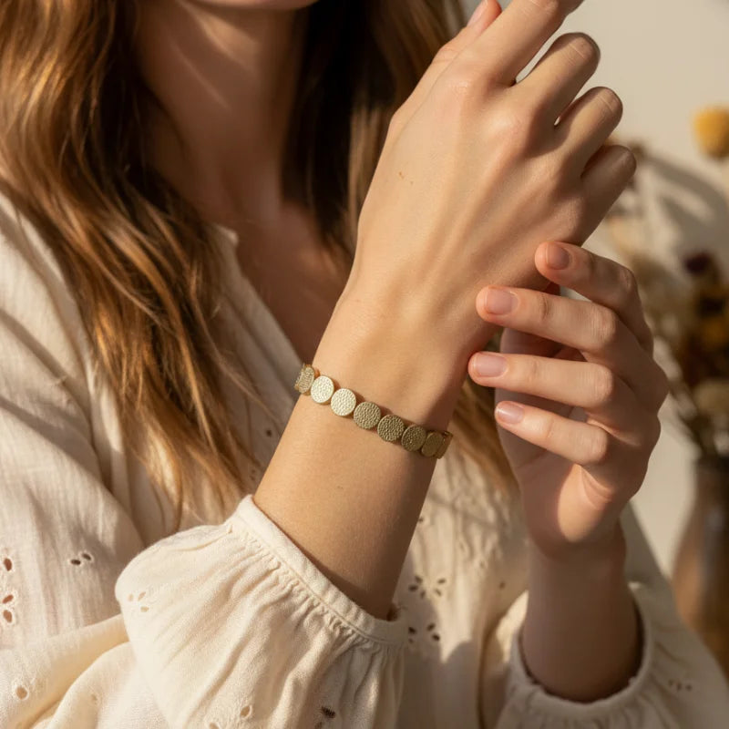 Matte gold tone textured disc stretch bracelet with woven design
