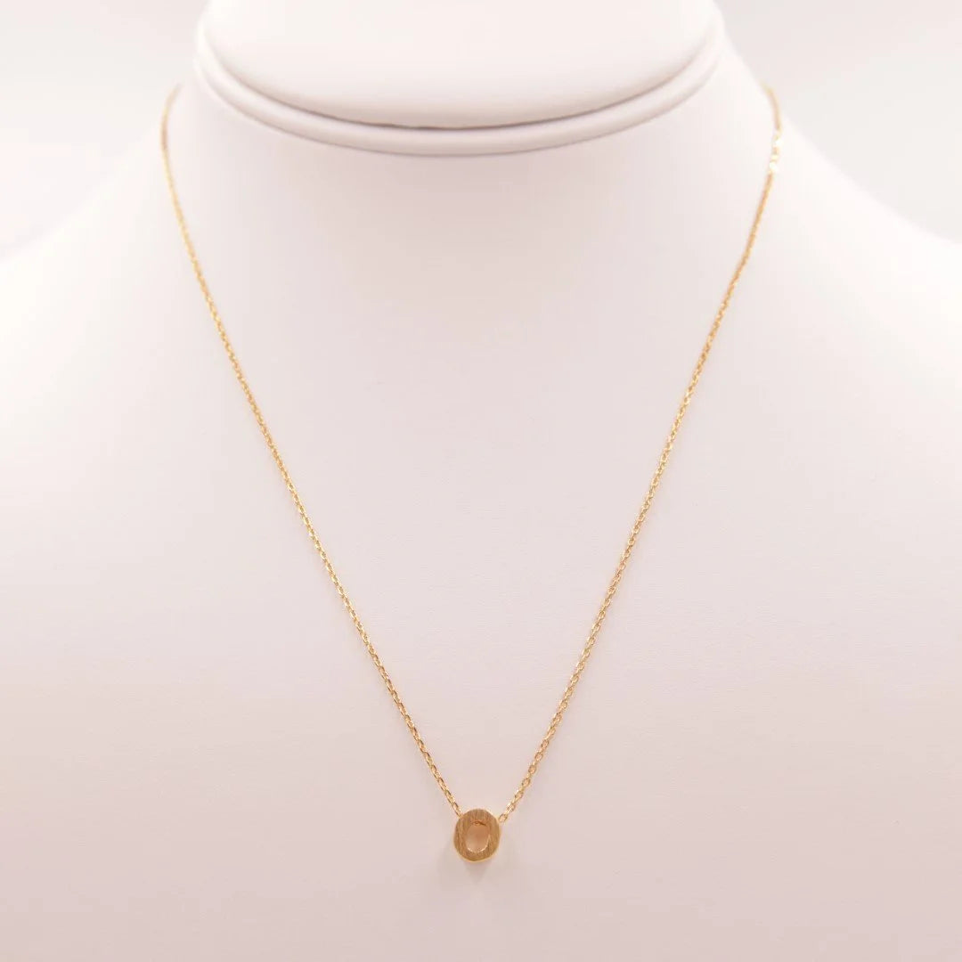 Gold coin necklace from Daisy Lane showcasing the Initial O design in dainty elegance