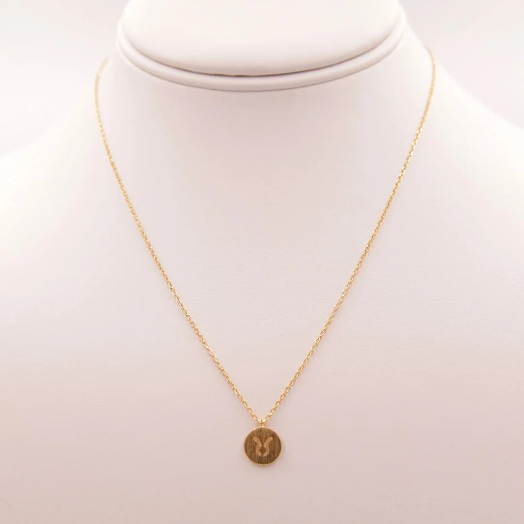 Gold coin Taurus Zodiac sign necklace elegantly displayed for stylish astrology enthusiasts