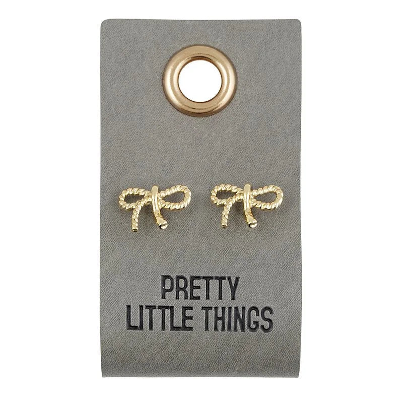 Gold bow-shaped stud earrings on a gray tag labeled Pretty Little Things leather tag boho style