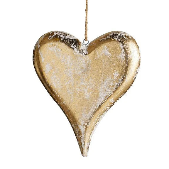 Gold heart ornament elegantly displayed, showcasing a gold heart hanging on a string