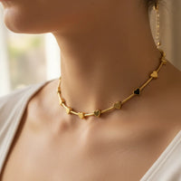 Golden heart charm necklace with black accents