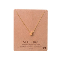 Gold heart necklace displayed on card in INITIAL J GOLD NECKLACE by Daisy Lane