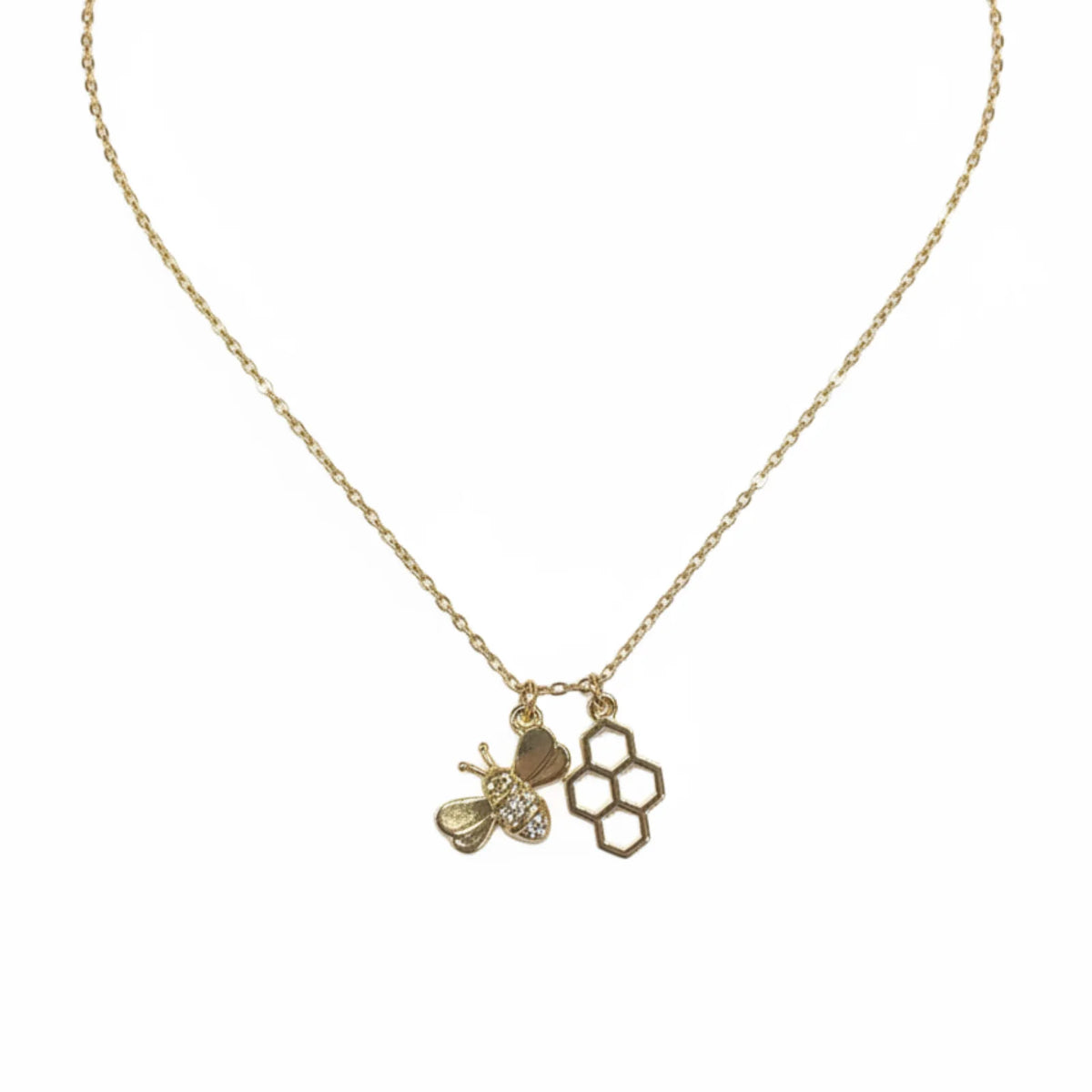 Gold honeycomb and bee charm necklace from Hive Rules Gold collection featuring a gold bee pendant