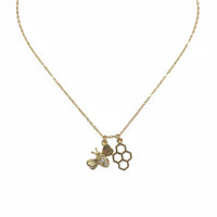 Gold honeycomb and bee charm necklace from Hive Rules Gold collection featuring a gold bee pendant