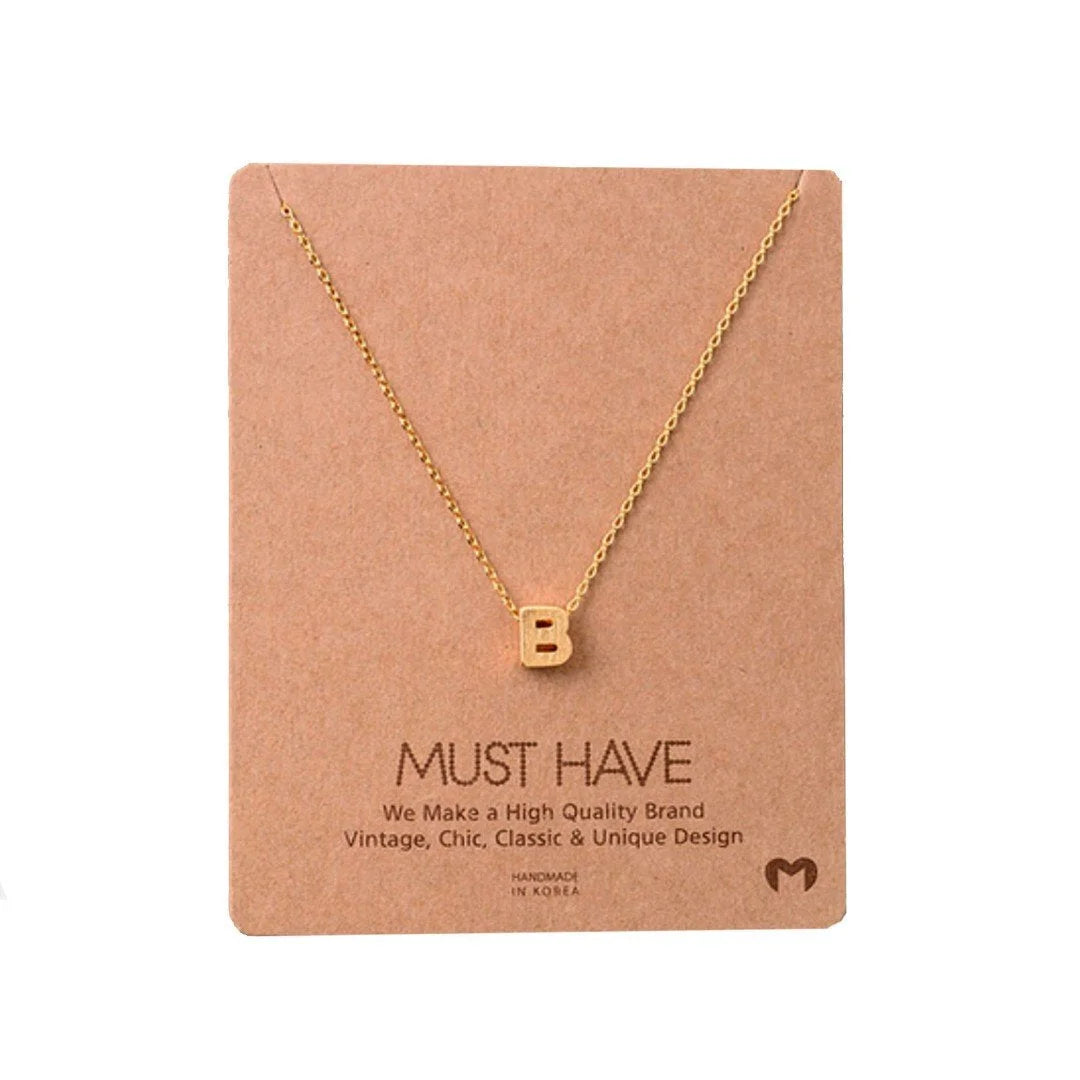 Gold Initial B Necklace displayed on a card from Daisy Lane’s dainty initial necklaces