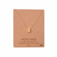 Dainty Initial Necklace displayed on a card by Daisy Lane, featuring a gold initial design