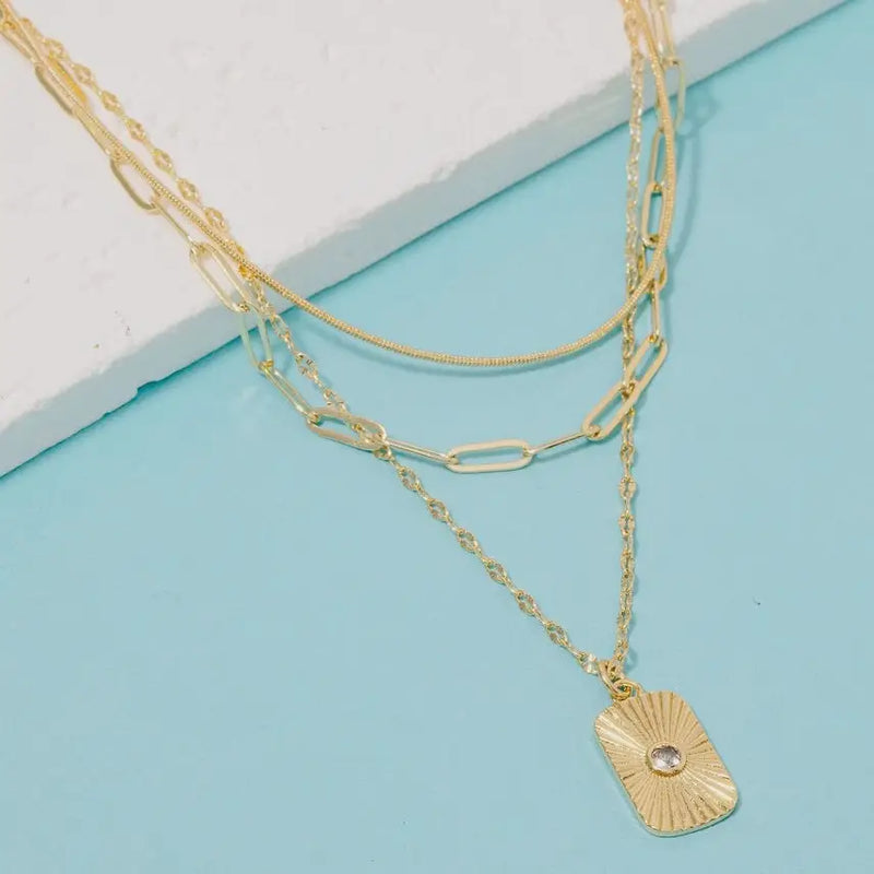 Gold dipped cubic zirconia dog tag pendant necklace with layered chain