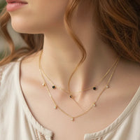 Golden earthy spirit layered necklace with black beads and small pendants