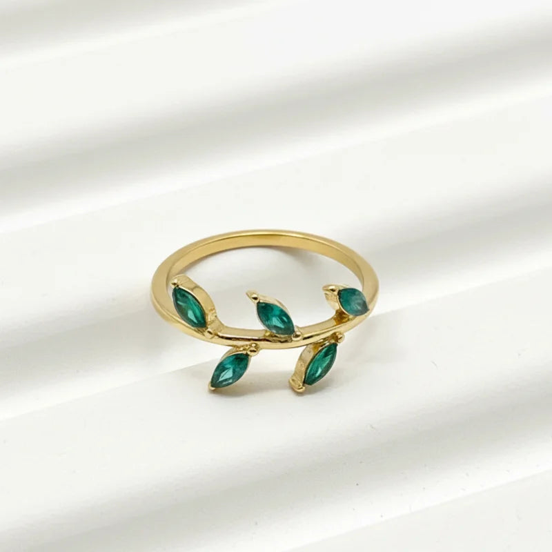 Gold emerald leaf vine ring with green gemstones