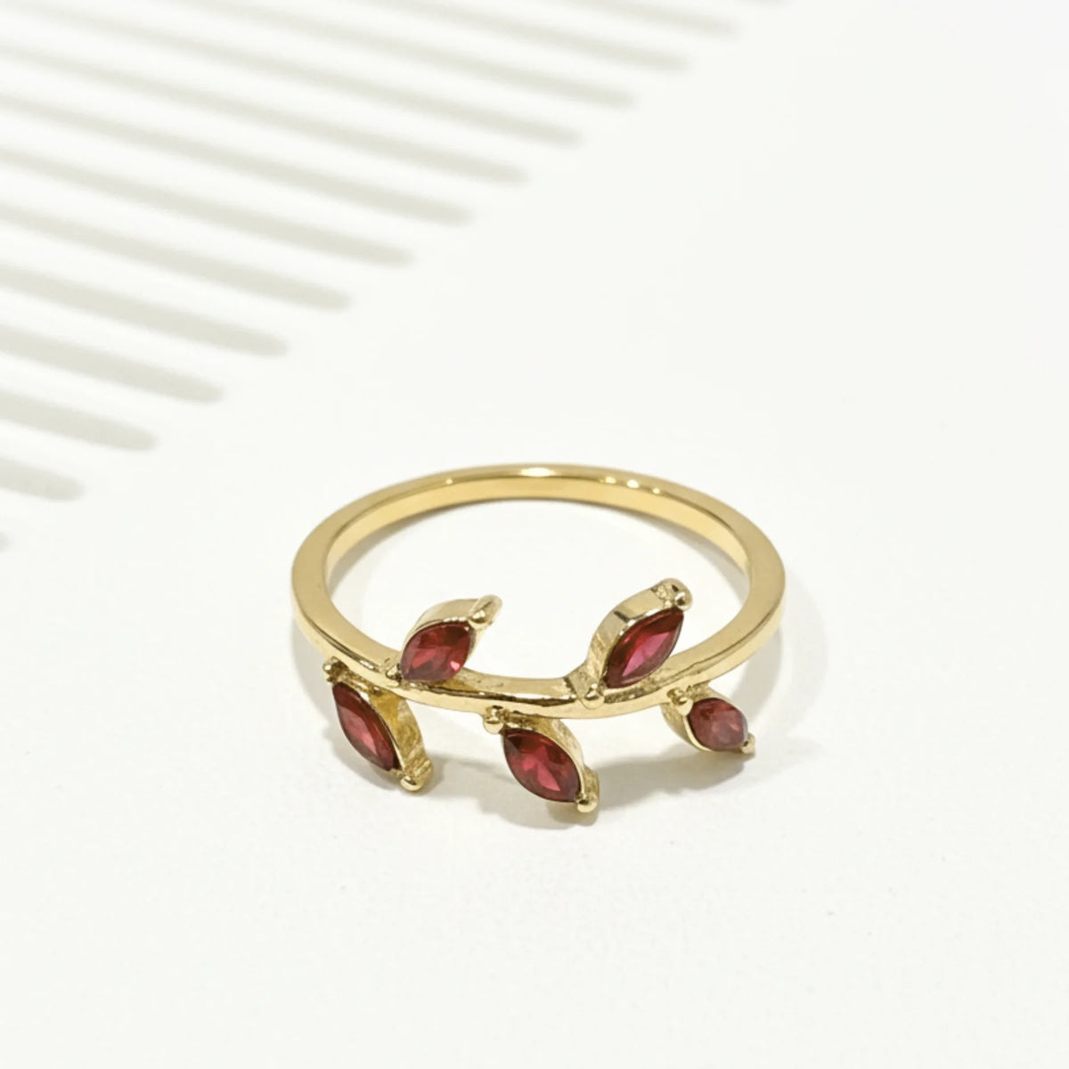 Gold emerald leaf vine ring with red gemstones