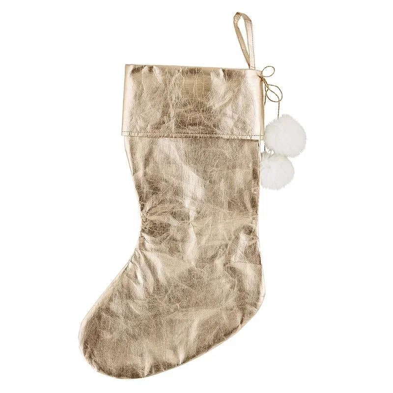 Gold metallic Christmas stocking with pom-poms from Shop Daisy’s Rose Gold collection