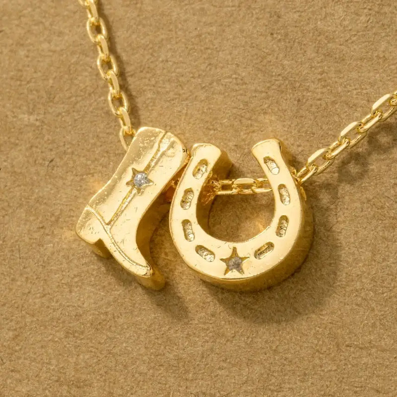 Gold dipped cowboy boots and horseshoe charm necklace, a trendy horse shoe charm necklace accessory