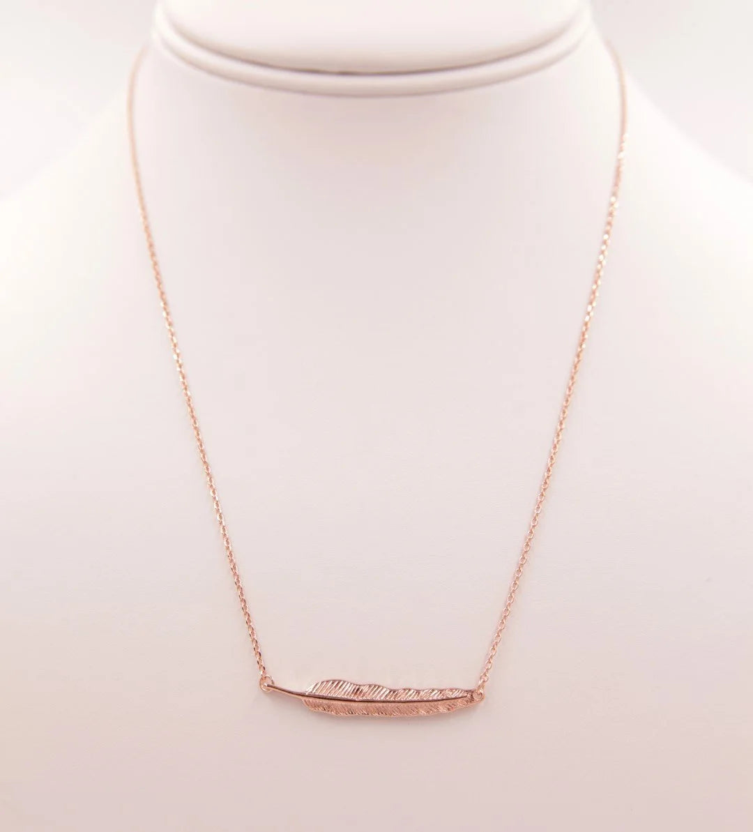 Gold Leaf Pendant Necklace featuring a stylish curved bar design for elegant wear