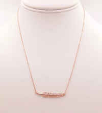 Gold Leaf Pendant Necklace featuring a stylish curved bar design for elegant wear