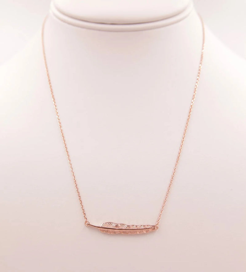 Gold Leaf Pendant Necklace featuring a stylish curved bar design for elegant wear