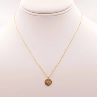 Gold Capricorn Zodiac Sign Necklace featuring a small coin charm for astrological lovers