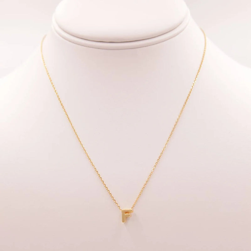 Dainty Initial F Gold Necklace with a small triangle pendant from Daisy Lane