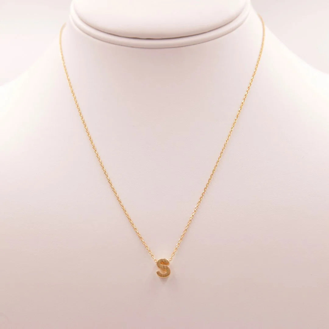 Gold INITIAL S GOLD NECKLACE featuring a small gold disc from Daisy Lane’s dainty initial collection