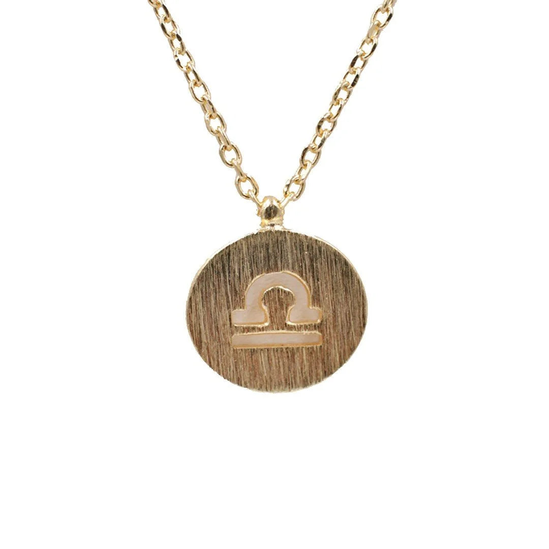 Gold Libra Zodiac Sign Necklace featuring a small gold disc pendant