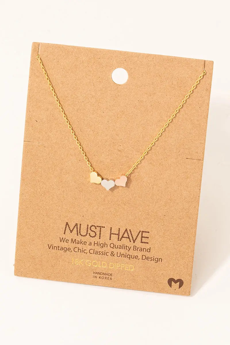 Gold three-tone dainty hearts necklace featuring three pendant charms