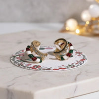 Festive candy cane sparkle clip-on earrings with gold, red, and rhinestones