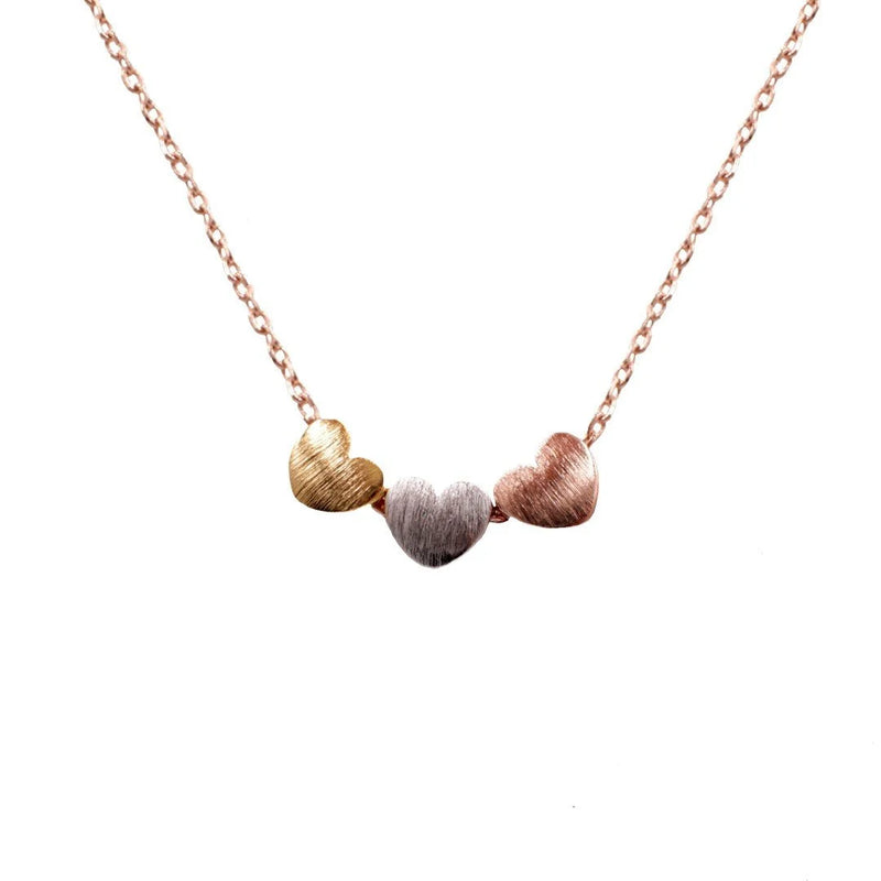 Gold and silver TRI-COLOR HEARTS NECKLACE featuring two small shells for elegant style