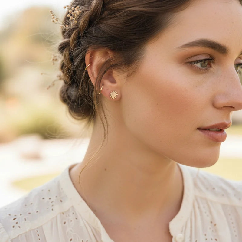 Free Spirit Gold sun-shaped stud earrings with intricate detailing