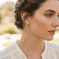 Free Spirit Gold sun-shaped stud earrings with intricate detailing