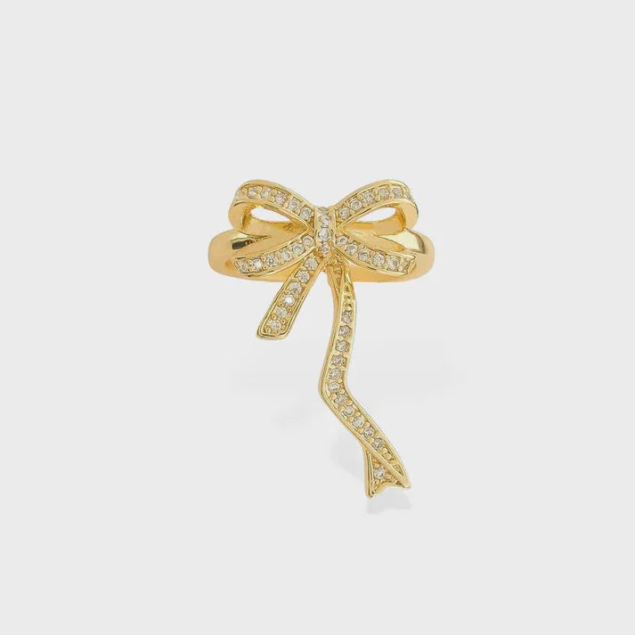 Gold-toned tied bow ribbon gold ring with clear diamond accents for elegant jewelry style